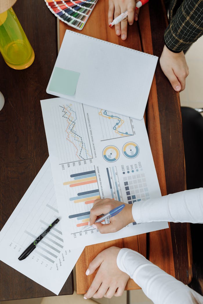 services-01 Top view of business team analyzing charts and data on paper for strategic planning.